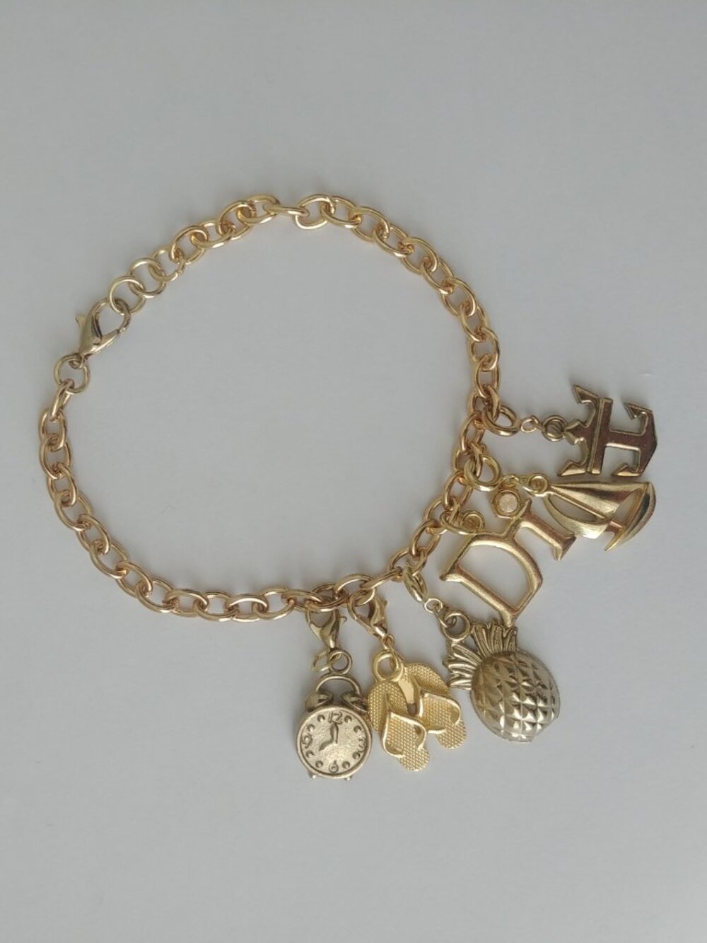 Gold tone charm link bracelet with six charms